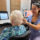 Amazing Hearing audiologist gently examining a patient's ear during a hearing evaluation in Orange County